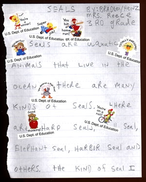 Prototypes of Department of Education stickers are tested on a third-grader's report on seals.